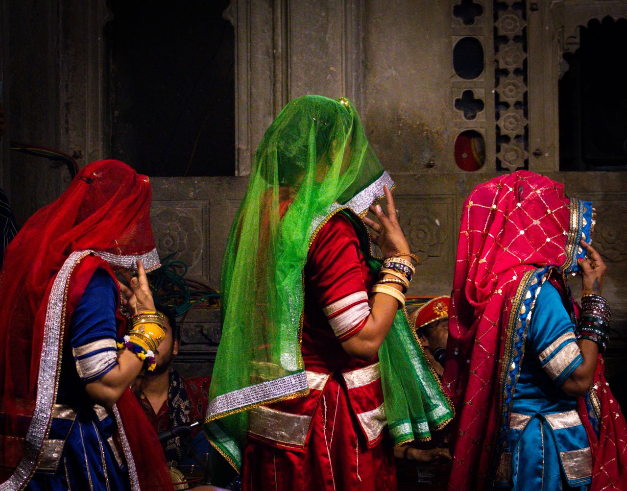 Traditional Rajasthani dancers in colorful attire performing a folk dance in Udaipur, India.